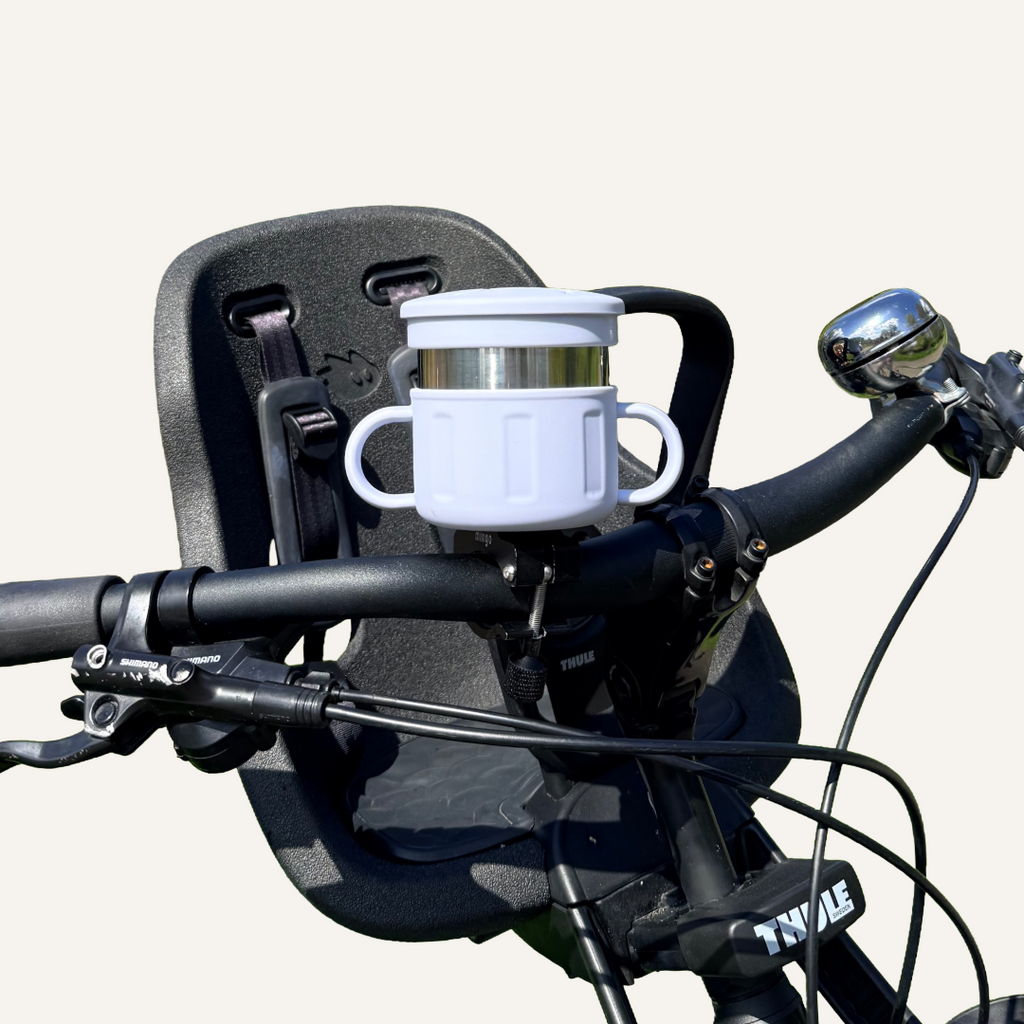blue snack cup mounted onto a black bicycle